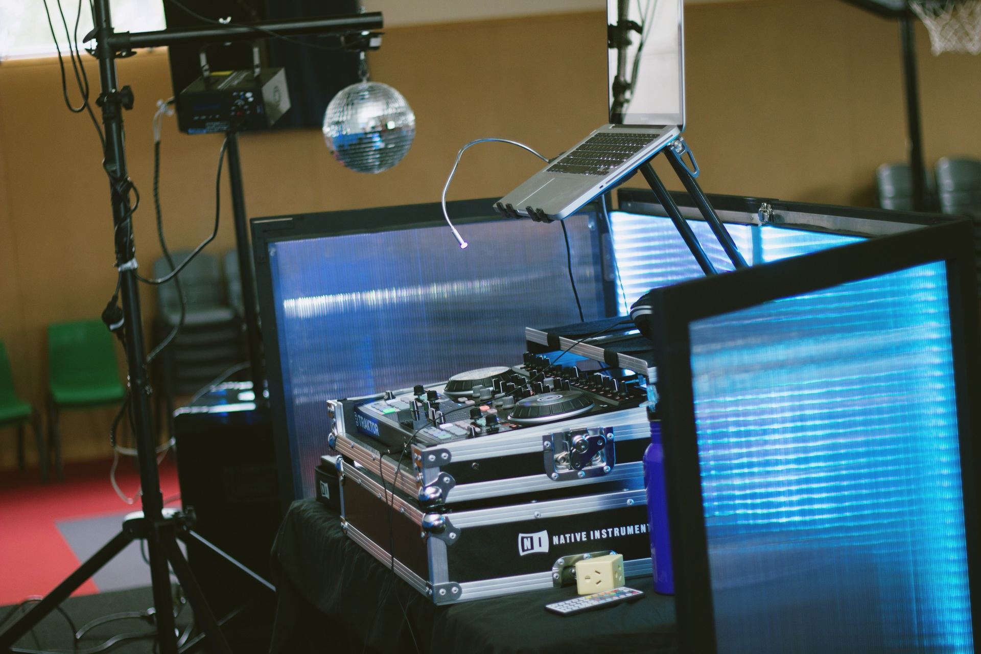 DJ booth set up with flight cases and lighting stands